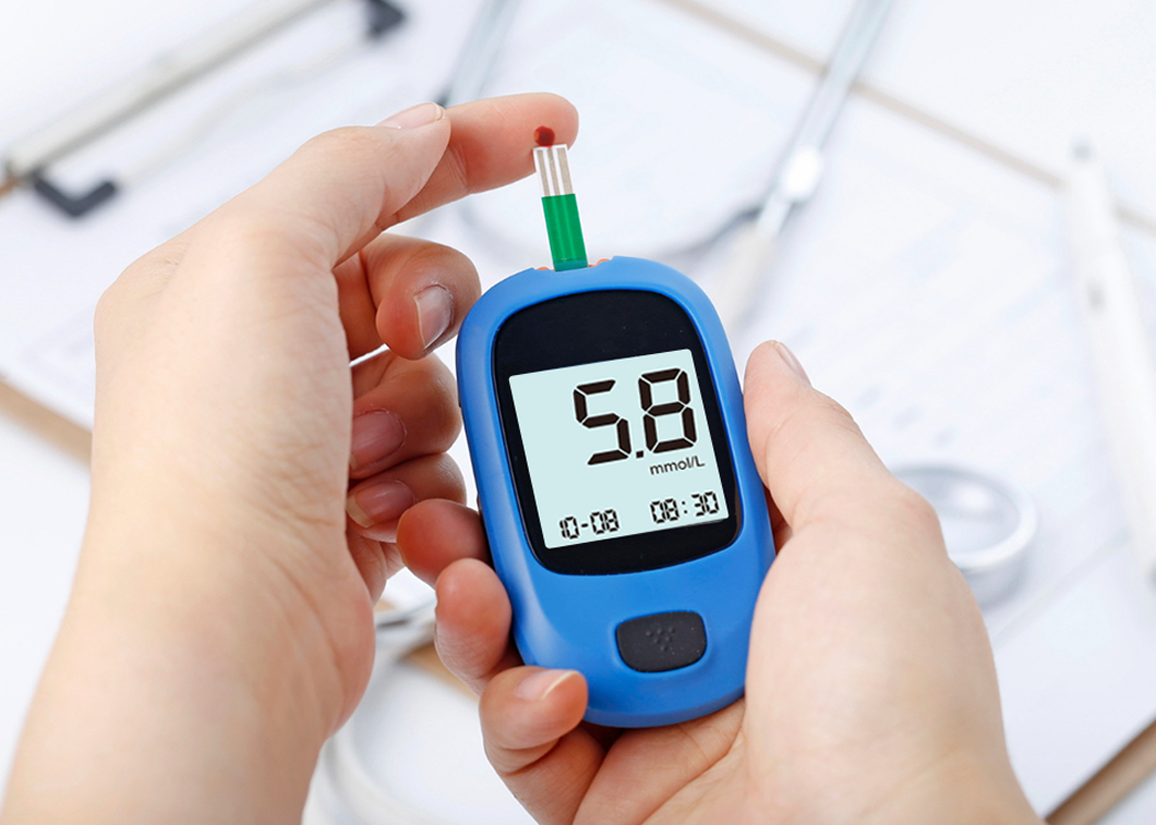 Digital glucometer showing blood sugar reading