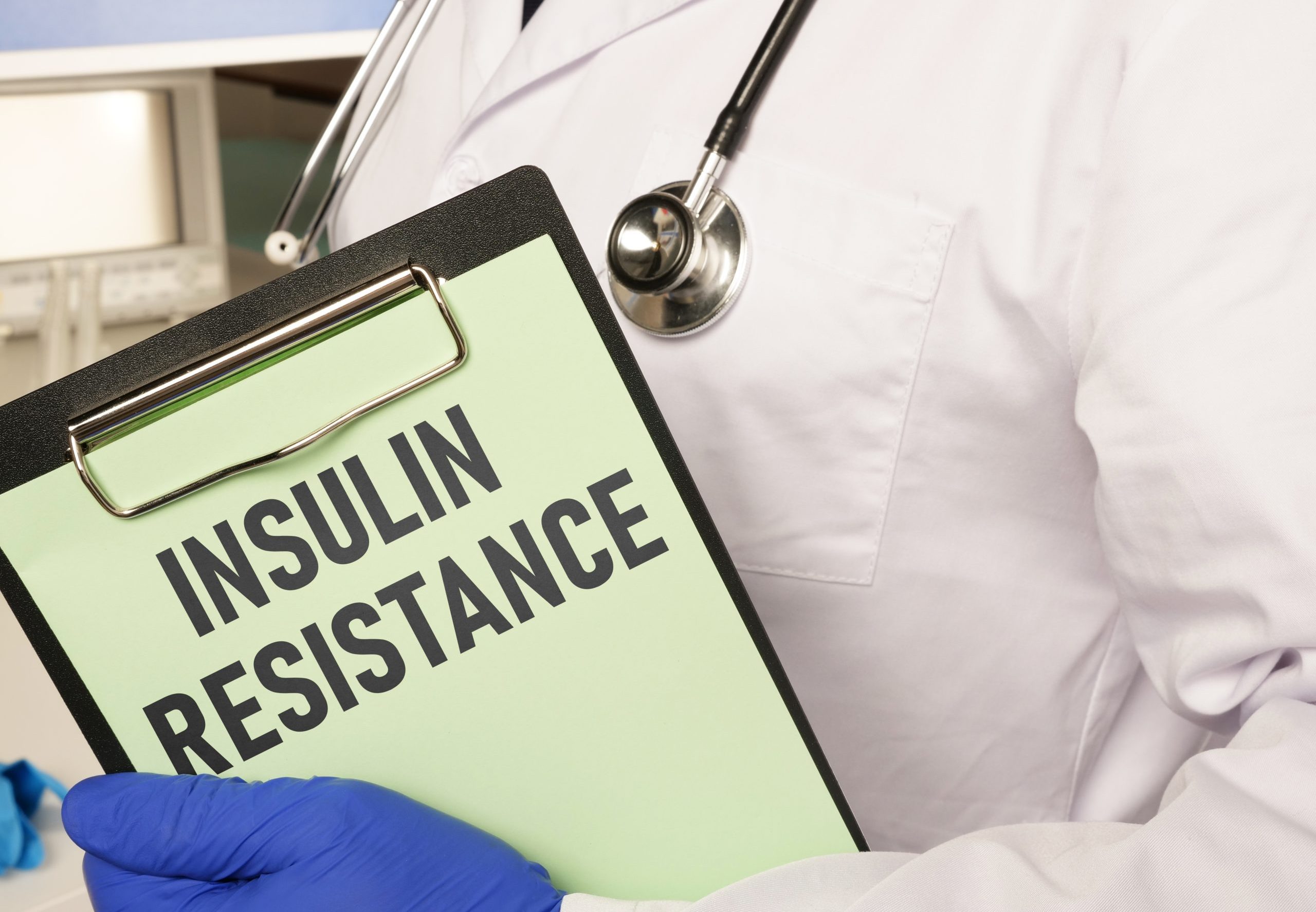 A doctor holding a board with an Insulin Resistance document, illustrating how to reverse insulin resistance naturally.