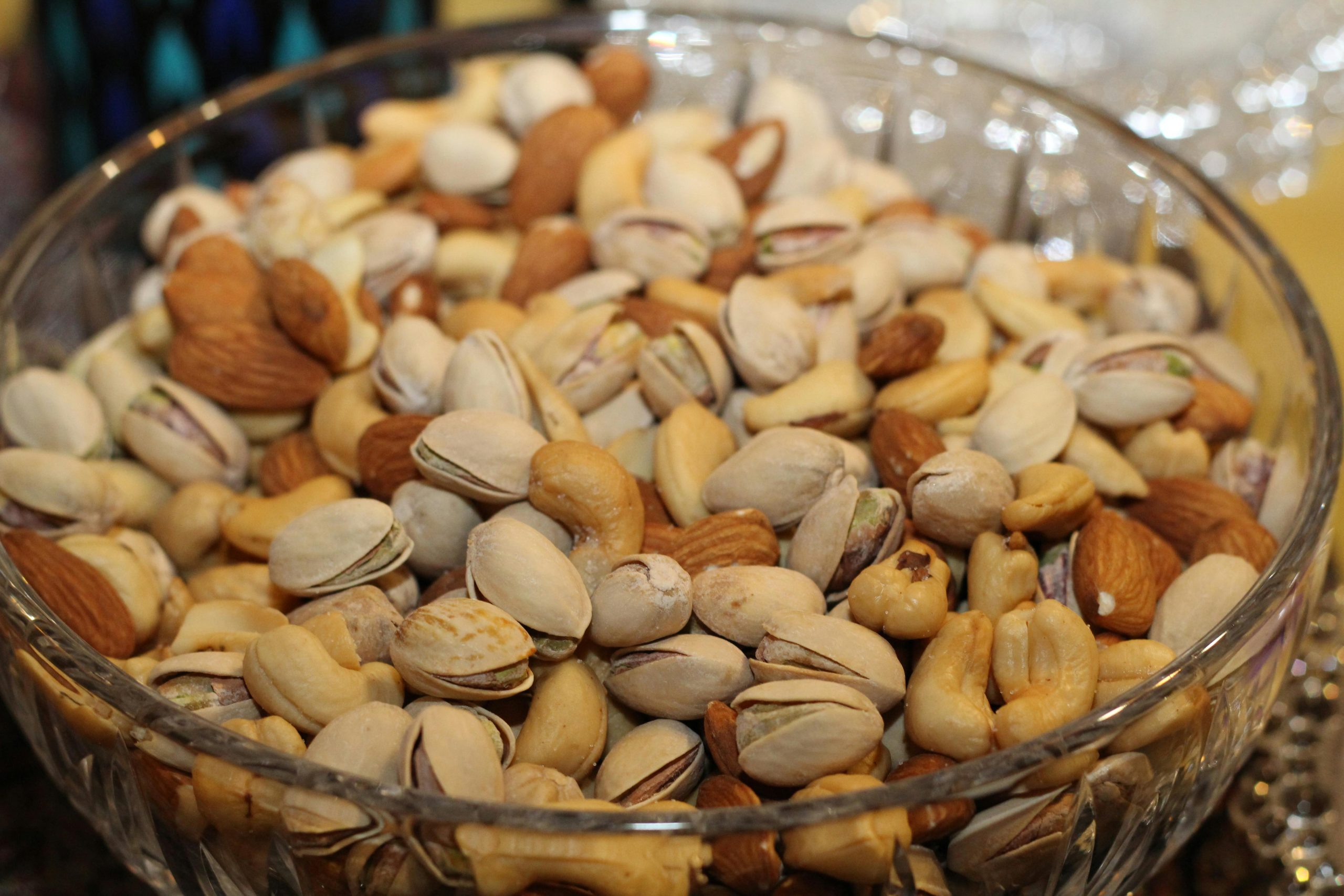 Bowl of assorted nuts on a wooden table, illustrating a healthy choice in the best diabetic snacks for travel or on-the-go.